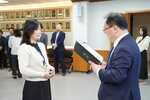 수시인사 임용장 수여식에서 정장을 입은 남성이 베이지색 상의를 입은 여성 직원에게 임용장을 전달하는 모습